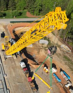 Tall yellow crane moving supplies
